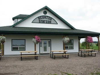 Outside picture of white and green community hall